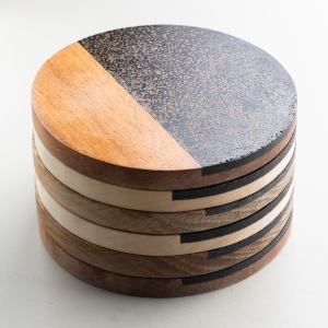Detailed side view of stacked coasters showing coffee shell texture made from reclaimed coffee grounds
